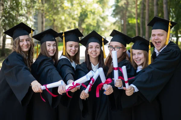 Row Happy Young People Graduation Gowns Holding Diplomas Outdoors — Stock Photo, Image