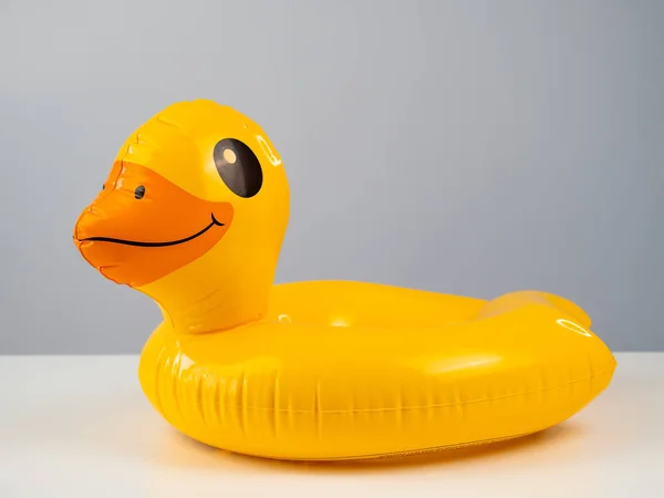 Inflatable yellow duck on a white table
