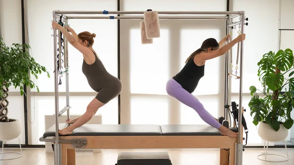 Two Pregnant Women Doing Pilates Cadillac Reformer — Stock Photo, Image