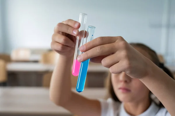 Egy Iskoláslány Kémiaórán Végez Kísérleteket Lány Összehasonlít Két Kémcsövet Színes — Stock Fotó