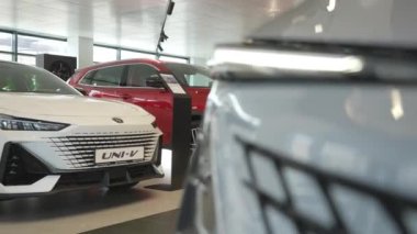 Bir araba galerisindeki Changan arabasının tamponuna yakın çekim. Hareket eden kamera