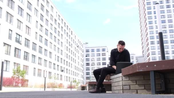 Man Types Laptop Outdoors Does Somersault — Stock Video