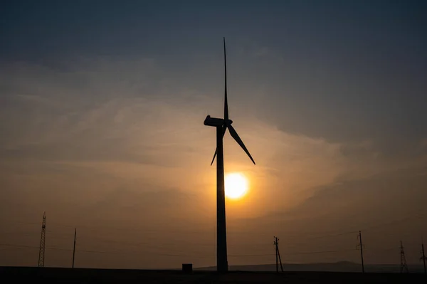 Windmill at sunset. Alternative energy source