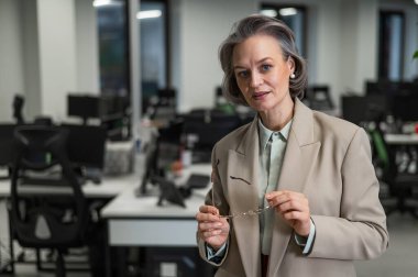 Portrait of an attractive mature caucasian woman in the office