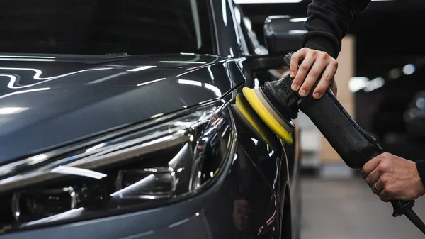 stock image A master polishes the surface of a car body