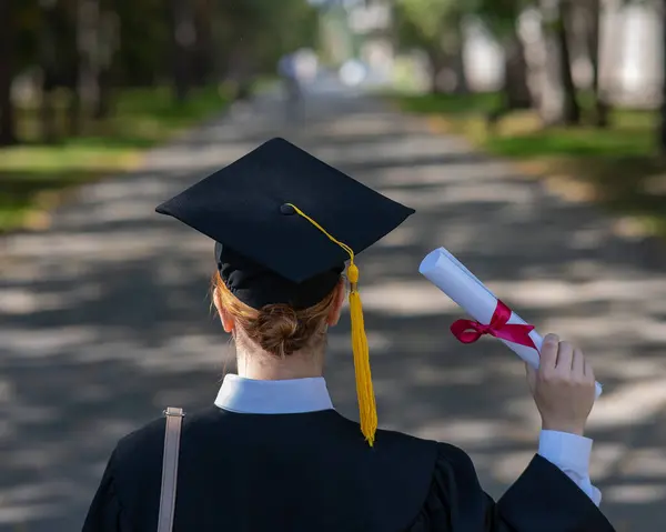Rear View Caucasian Woman Graduate Gown Holding Diploma Outdoors — Stock Fotó