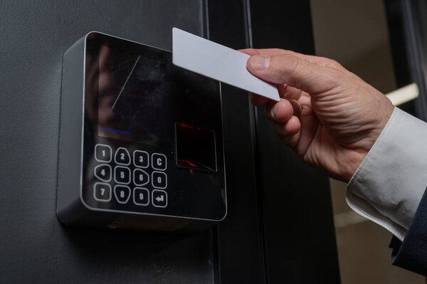 A man opens the door with a card. Modern electronic lock. Keyless Entry. 