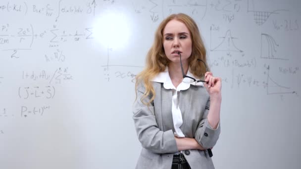 Caucasian Pensive Woman Stands White Board Written Formulas — Stock Video