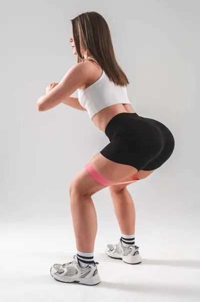 Mulher Caucasiana Fazendo Agachamentos Com Faixa Fitness Fundo Branco Foto — Fotografia de Stock