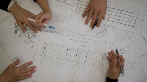 Top View Hands Four Colleagues Blueprints Table Office Brainstorming Engineers — Stock Video