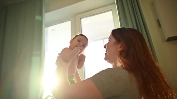 Caucasian Woman Tenderly Kisses Lifts Her Newborn Son — Stock Video