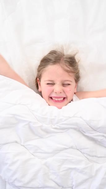 Top View Grimacing Little Girl Lying Bed Vertical Video — Stock Video