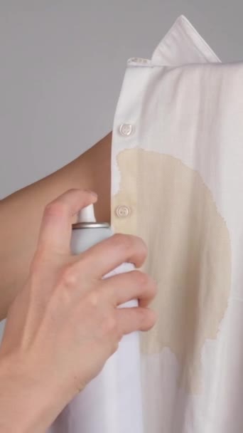 女人用去污剂喷涂办公室白衬衫和咖啡污渍 这个女孩把漂白剂用在她的衬衫上 垂直录像 — 图库视频影像