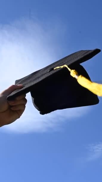 Close Womans Hand Graduation Cap Blue Sky Vertical Video — Stock Video