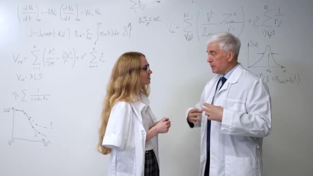 Elderly Man Young Woman Dressed Laboratory Coats White Board Colleagues — Stock Video