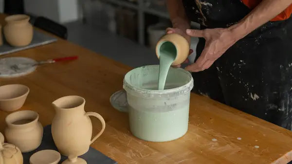 stock image Close-up of a potters hands glazing a pottery piece