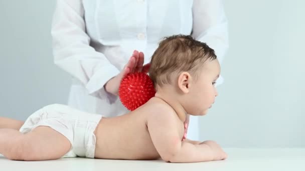 Seorang Dokter Memberikan Anak Pijat Punggung Menggunakan Bola — Stok Video