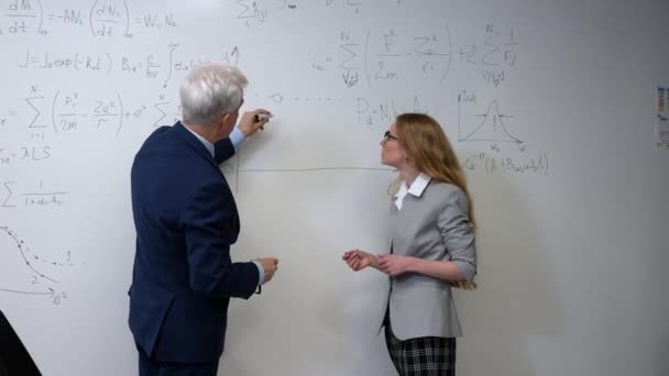 Elderly Professor Explains Subject Student White Board — Stock Video