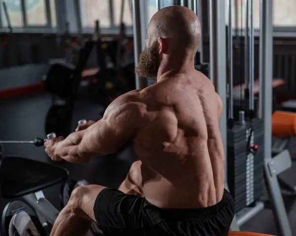 stock image Caucasian man doing rowing exercises on a rowing machine