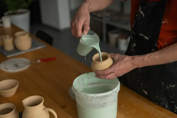 stock image Close-up of a potters hands glazing a pottery piece