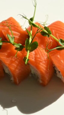 Set of philadelphia rolls spin on a white background. Vertical video