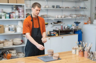 Potter kneads clay before using it in the workshop