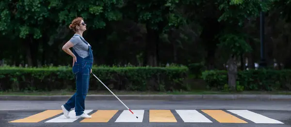 stock image Blind pregnant woman crosses the road at a crosswalk with a cane