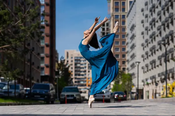 Dışarıda dans eden güzel bir Asyalı balerin. Şehir manzarası