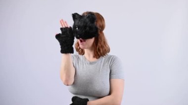 Beyaz arka planda kedi kostümü giymiş bir kadının portresi. Kuadrober