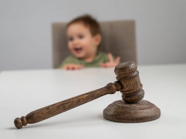 Little boy behind judges gavel clipart