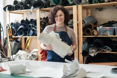 Woman tanner at work in the workshop clipart