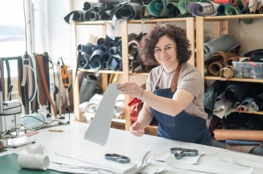 Woman tanner at work in the workshop clipart