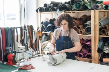 Woman tanner at work in the workshop clipart