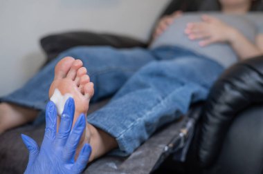 Güzellik salonunda hırdavat pedikür yapan hamile bir kadın.