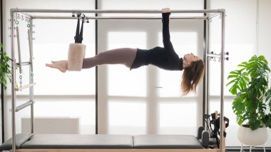 Kafkas kadın yenilikçi bir makine üzerinde hava egzersizleri yapıyor.