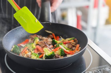 Biftek ve sebze kızartma tavasında kızartılır.