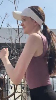 Genç beyaz kadın dışarı koşuyor.