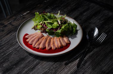 Kızarmış ördek bir tabakta parçalara ayrılmış.