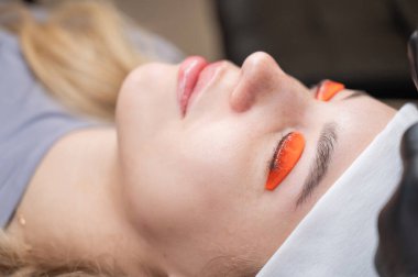 Beyaz kadın kirpik temizleme prosedüründen geçiyor.