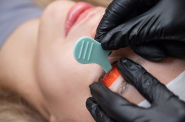 Beyaz kadın kirpik temizleme prosedüründen geçiyor.