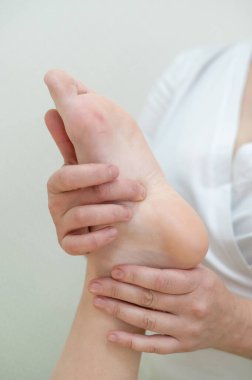 Bir kadının ayağına masaj yapılıyor.