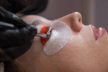 Beyaz kadın kirpik temizleme prosedüründen geçiyor.