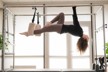 Kafkas kadın yenilikçi bir makine üzerinde hava egzersizleri yapıyor.