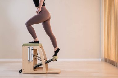 Pilates yapan kadın klasik sandalye.