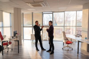 Ofiste konuşan iki beyaz adam.