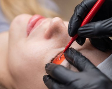 Beyaz kadın kirpik temizleme prosedüründen geçiyor.