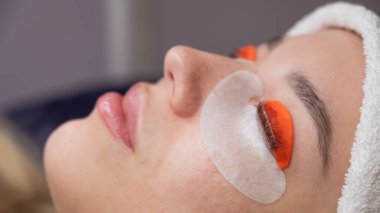 Beyaz kadın kirpik temizleme prosedüründen geçiyor.