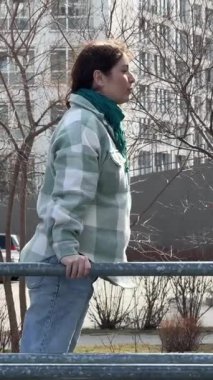 Beyaz kadın paralel barlarda egzersiz yapıyor.