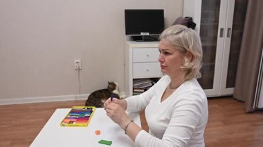 Olgun kadın çocuk plastiklerinden heykel yapıyor.