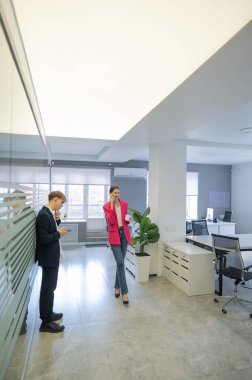 Meslektaşlar iş aralarında akıllı telefon kullanırlar